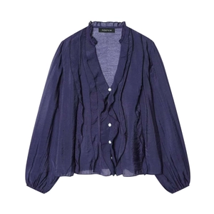 Detail of elegant navy blue chiffon blouse with ruffled neckline and silk-like texture