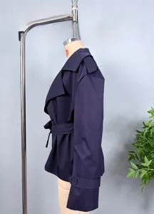 Detailed side view of a short dark purple belted trench jacket with lapels and cuff straps