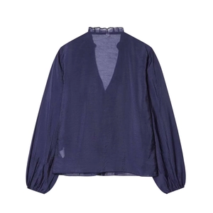 Detail of deep purple blouse with ruffled stand collar and elegant lantern sleeve cuffs