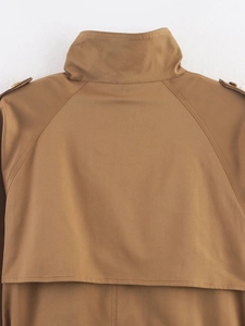 Detailed view of the khaki trench coat featuring shoulder epaulettes and windproof stand collar