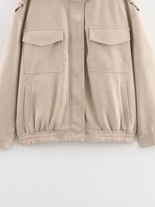 Detail of beige faux suede jacket featuring large chest pockets and shoulder epaulettes