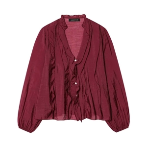 Detail of burgundy V-neck chiffon blouse with elegant ruffles and white buttons