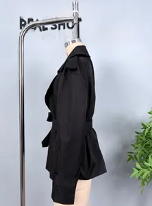 Detailed side view of black short trench jacket featuring waist belt and buckle cuffs