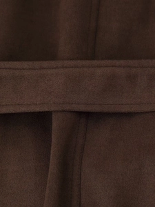 Detailed view of dark brown faux suede jacket featuring precision stitching on the belt