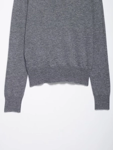 Detailed view of dark grey diamond pattern knit cardigan with ribbed hem and cuffs