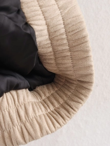 Macro detail of ribbed knit cuff with smooth black inner lining and premium stitching