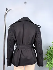 Rear view of black short trench jacket with waist belt and epaulettes on mannequin