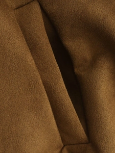 Macro view of high-quality dark brown faux suede fabric texture with refined stitching