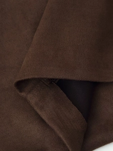 Macro detail of faux suede fabric with precise stitching and black inner lining