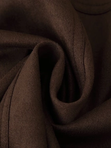 Detail shot of the dark brown faux suede jacket fabric with rich fiber texture