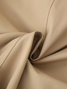 Detail of khaki twill cotton fabric with high-quality double-needle stitching on short trench coat