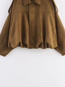 Detailed close-up of dark camel suede jacket featuring lapel collar and shoulder epaulettes