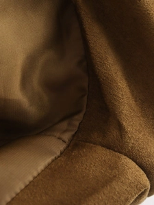 Detail of premium brown suede aviator jacket with smooth polyester lining and neat stitching