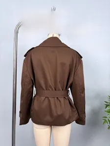 Detailed back view of a brown cropped trench jacket featuring a belt and shoulder epaulettes
