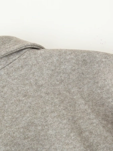 Close-up of double-layer collar stitching and oatmeal grey wool fabric texture