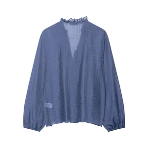 Detailed macro view of dark blue shirt with vertical pleated texture and ruffle v-neck