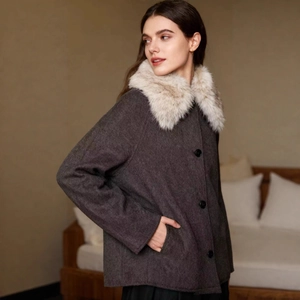 Women's dark charcoal wool coat featuring a plush faux fur collar and classic button closure