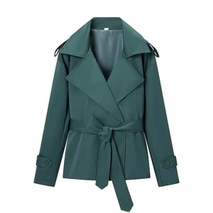 Detail of dark green short trench coat with adjustable cuffs and waist belt