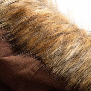 Macro detail of high-density brown twill jacket fabric and plush faux fur collar