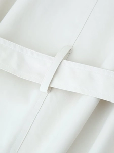 Detail of the high-quality woven waist belt and sturdy loops on a cream trench coat