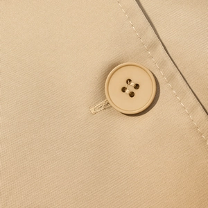 Macro detail of khaki twill fabric texture and high-quality four-hole resin button