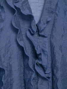 Close-up of Morandi blue chiffon blouse with layered ruffles and textured fabric detail