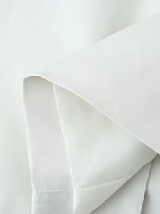 Detailed close-up showing the premium twill fabric texture and smooth satin lining of the coat