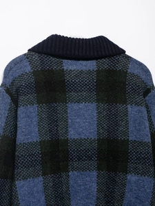 Dettaglio della classica trama a scacchi e del tessuto in maglia grossa del cardigan blu