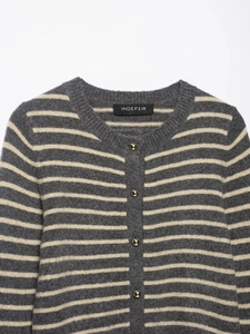 Detail of striped knit cardigan featuring golden domed buttons and a soft wool texture