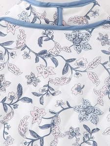 Detailed macro view of quilted floral cotton fabric with blue trim and diamond stitching