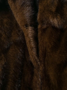 Detailed macro view of high-quality dark brown faux fur texture on the jacket collar