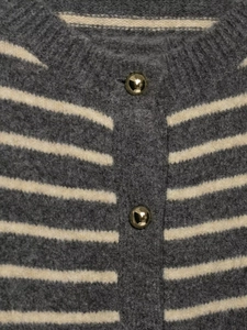 Macro shot of striped knit cardigan with textured wool fabric and gold metallic buttons