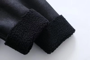 Macro detail of faux leather jacket cuff with thick black fleece lining texture