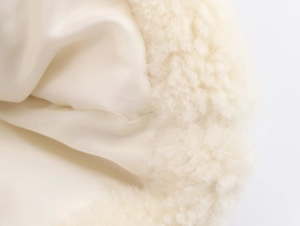 Detail of soft white faux fur texture and smooth satin lining on a winter coat