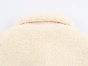 Close-up of the plush cream faux fur texture and collar detail on this warm winter coat