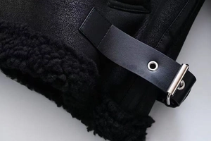 Detailed macro view of black faux leather texture and thick fleece lining on jacket