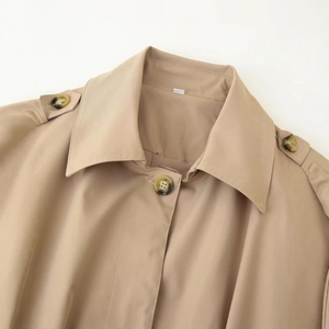 Classic khaki short trench coat with notched lapels, epaulettes, and amber-toned buttons