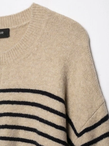 Detailed close-up of striped knit sweater collar and premium ribbed stitching texture