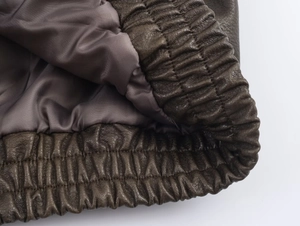 Macro detail of faux suede jacket showing elasticated hem and smooth inner lining