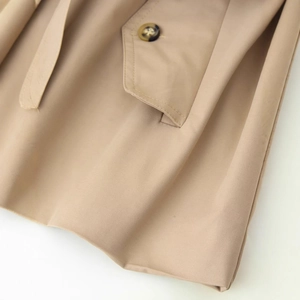 Short khaki trench coat for women with belted lapel and buttoned pocket detail