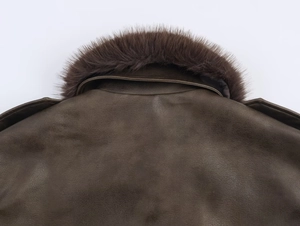 Detailed close-up of dark brown suede jacket featuring a soft removable faux fur collar
