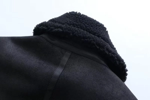 Close-up of black faux suede jacket featuring thick sherpa collar and leather details