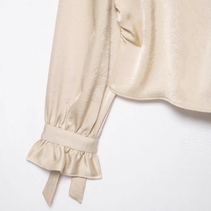Elegant champagne satin shirt with crinkled texture and ruffled tie-up cuffs