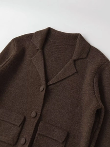 Close-up of deep brown knit cardigan featuring notch lapels and textured wool blend fabric