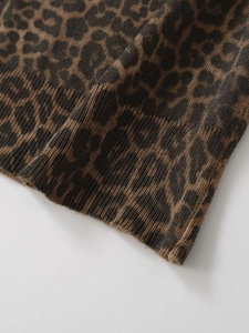 Detailed macro of soft leopard print knit fabric with ribbed cuff finish on long sleeve
