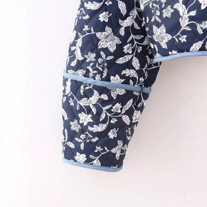 Reversible quilted jacket featuring dark blue floral prints and diamond stitching detail