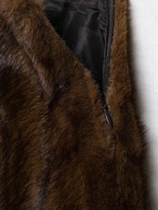 Detail of dark brown faux fur jacket with a hidden zipper and premium lining