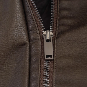 Close-up of gunmetal zipper and rectangular puller on dark brown faux suede jacket