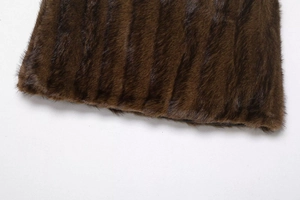 Close-up of brown faux fur texture and black fabric lining on the jacket hem