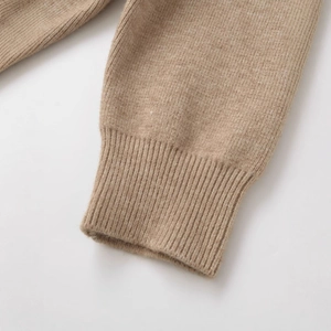 Close-up of light camel faux fur collar jacket showing soft knitted texture and ribbed cuff